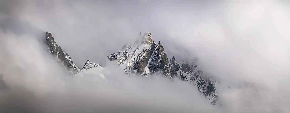 Chamonix peaks in the clouds, french alps