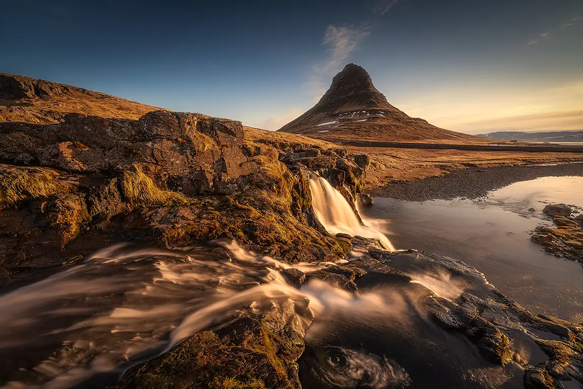 Setting sun at kirkjufellsfoss, kirkjufell, iceland