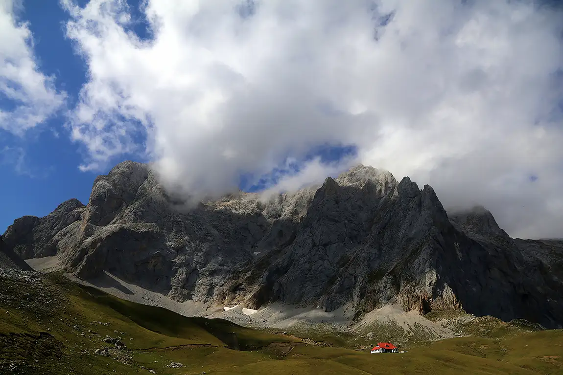 Red roof house below the ridge, picos de europa, spain