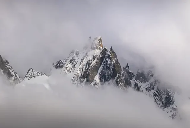 Chamonix peaks in the clouds, french alps