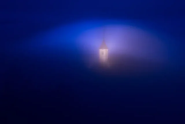 Dawn mist at jamnik church, near kropa, slovenia