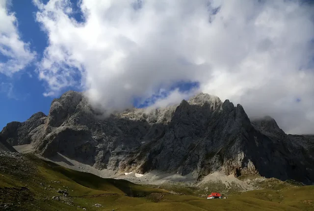 Red roof house below the ridge, picos de europa, spain