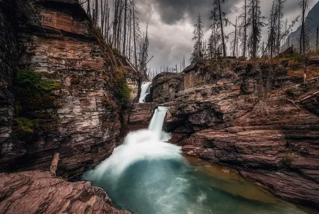 Stormy st mary falls in rocky canyon, glacier national park, montana, usa