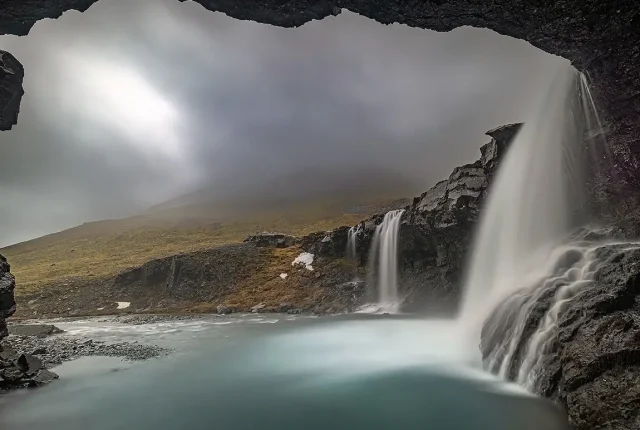 Under a moody weather waterfall, skutafoss, iceland